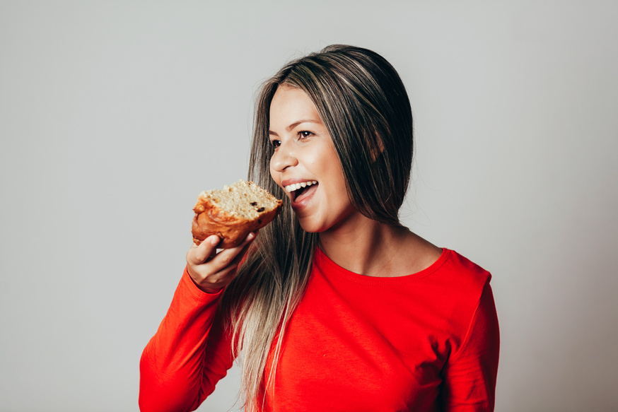 Brazilian young woman eating panettone. Young woman eating bread.